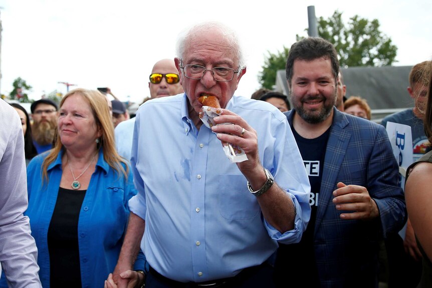 Bernie Sanders eating a corn dog