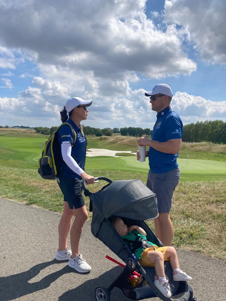 Stacey talks to Luke on a pathway on the golf course while Zoe is in the pram sleeping.