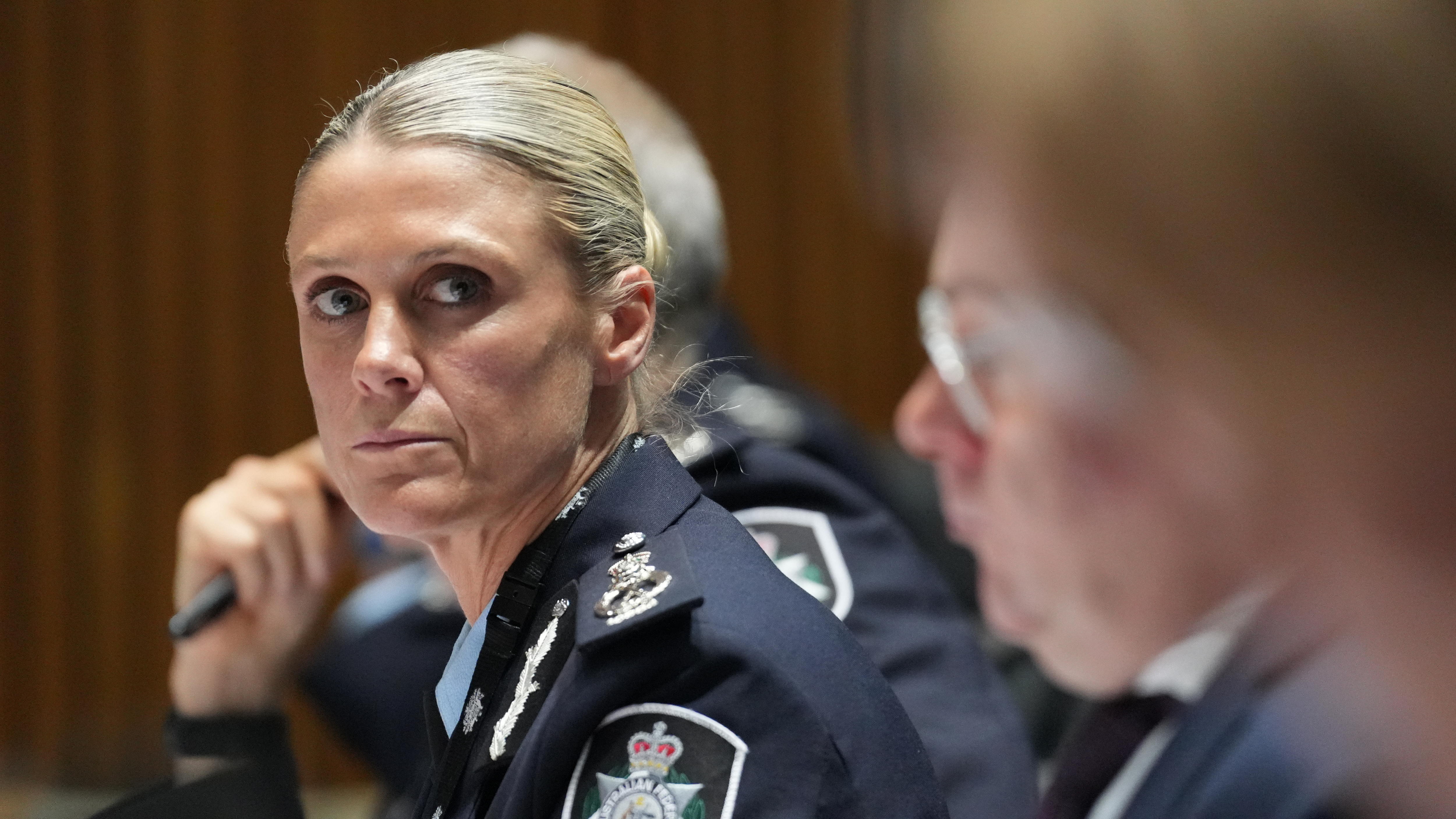 Krissy Barrett in dark blue AFP formal uniform looking to her left towards the camera lens.