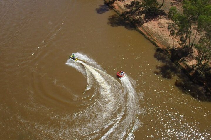 Aerial view of water skiing on the Finke River at Henbury Station