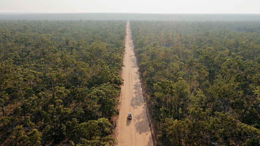 An aerial view of a 4WD on a dirt road in remote Arnhem Land. 