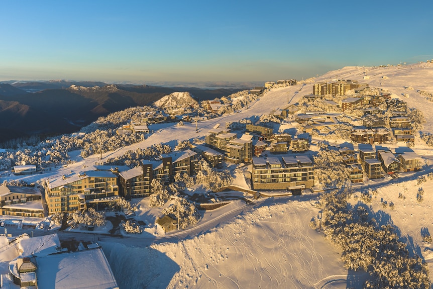 A aerial view of an alpine ski resort covered in snow.