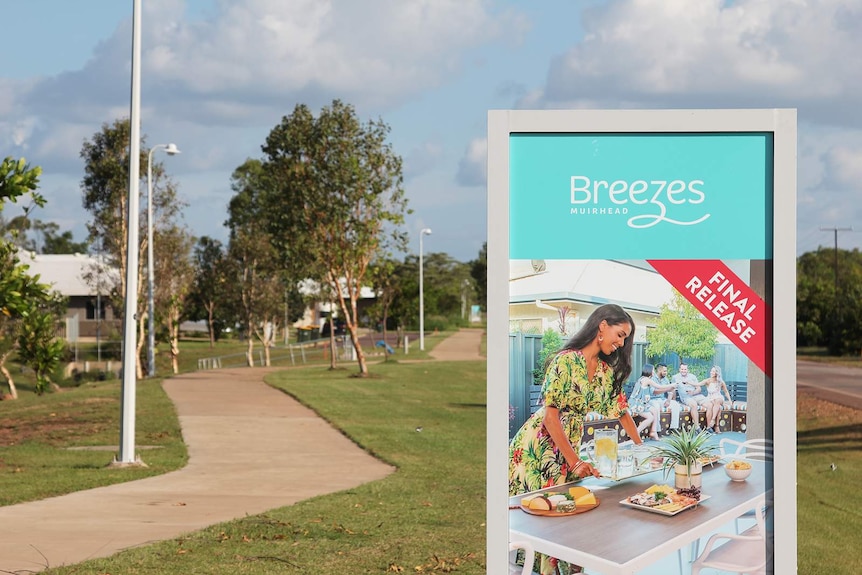 A photo of a sign advertising Breezes Muirhead on a footpath in Darwin.