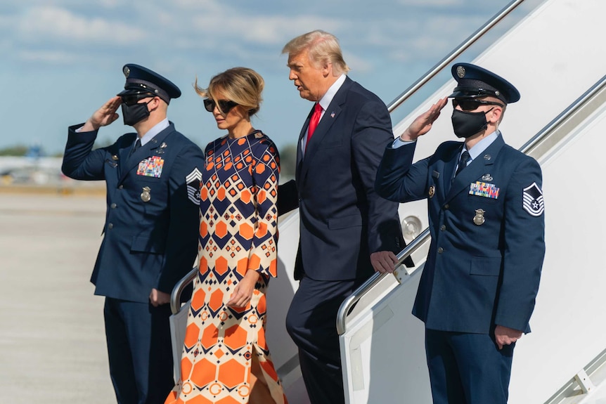 Donald and Melania Trump disembark of off Air Force One
