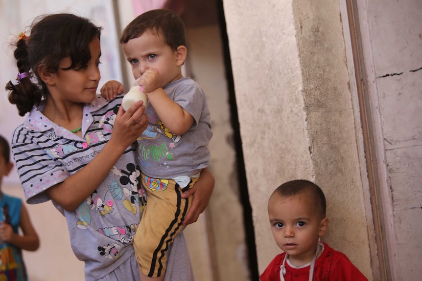 Iraqi Turkmen children take shelter at a school