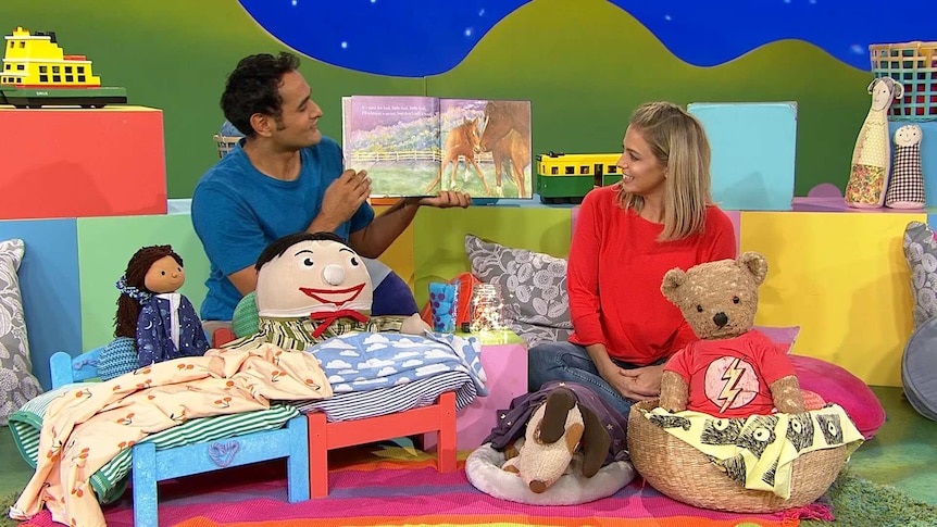 Nicholas and Rachael reading a book on the Play School set with the Play School toys