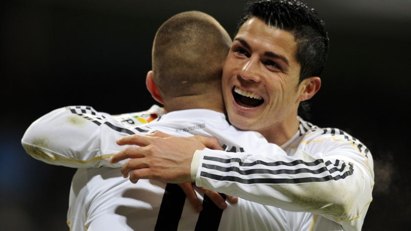 Six-star rout: Cristiano Ronaldo celebrates with French striker Karim Benzema.