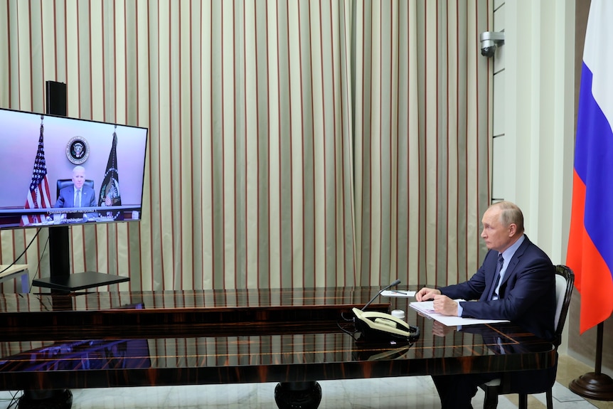 Russian President Vladimir Putin talks with U.S. President Joe Biden via a video screen.