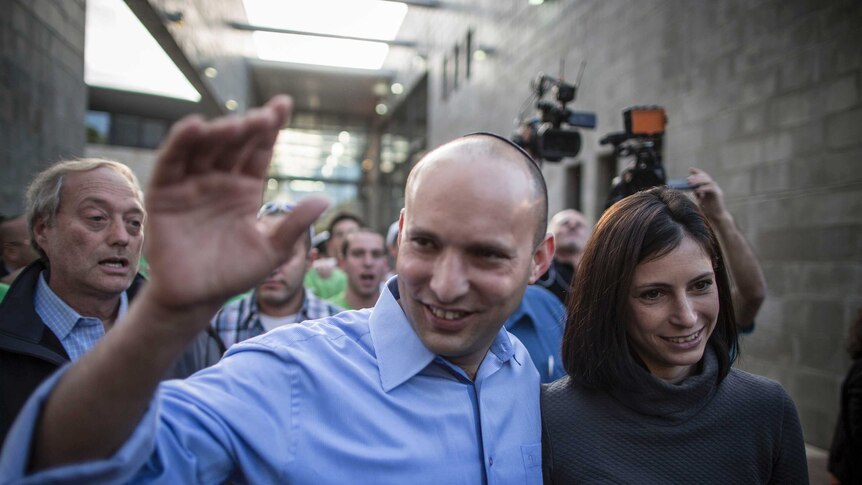 Bayit Yehudi (Jewish Home) party leader Naftali Bennett waves to supporters alongside his wife