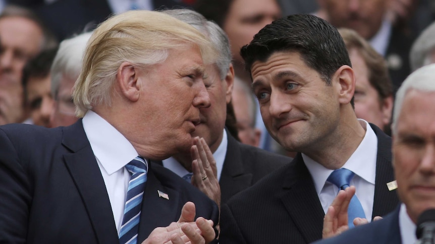 US President Donald Trump turns to House Speaker Paul Ryan.