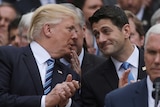 US President Donald Trump turns to House Speaker Paul Ryan.