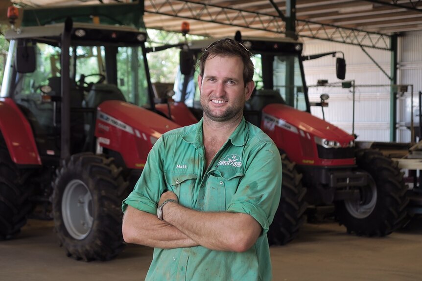 Ord farmer Matt Gray standing in front of tractors.