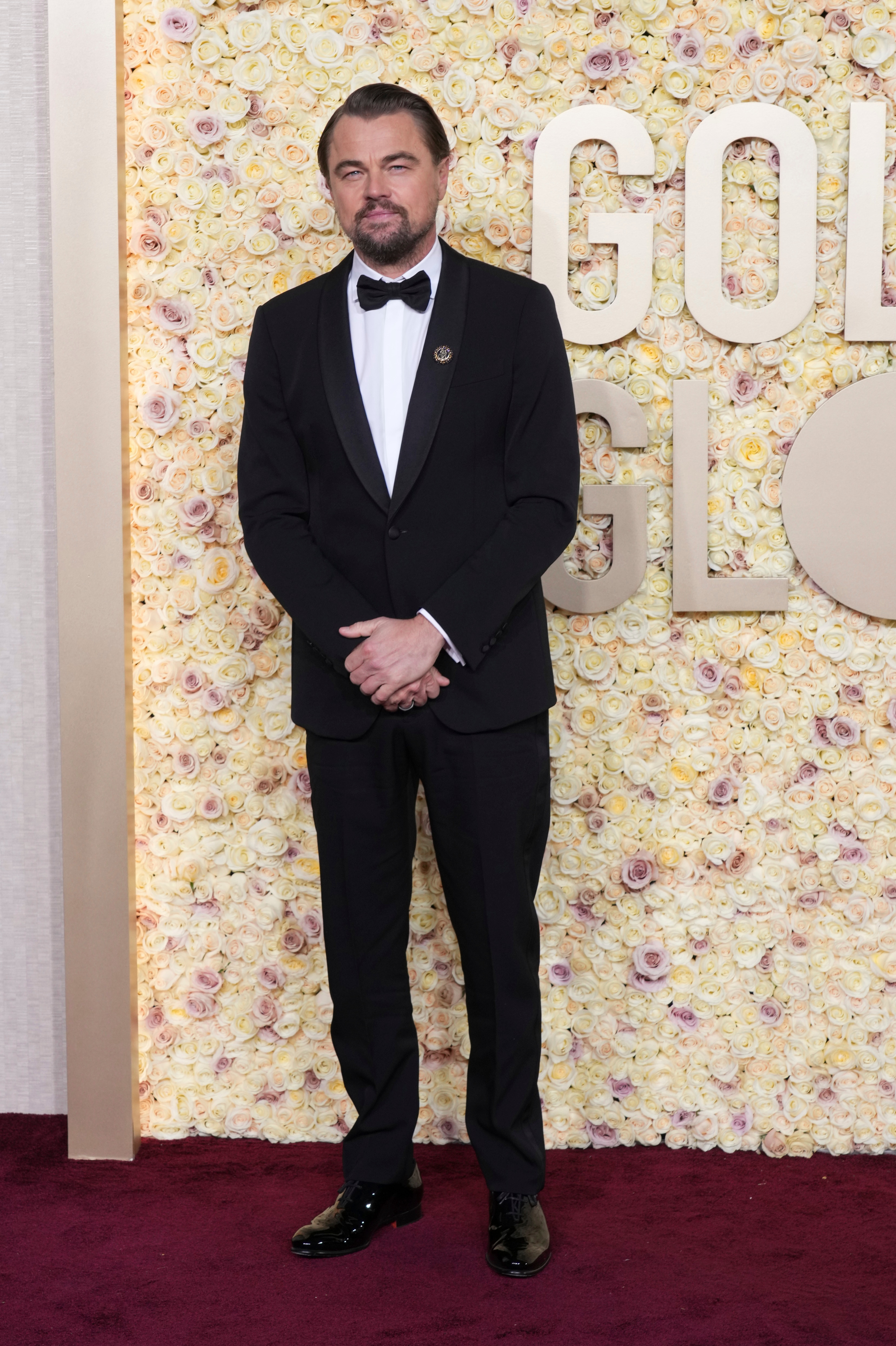 Actor Leonardo DiCaprio in a black suit on the red carpet