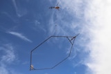 A helicopter lifts a giant electro-magnet