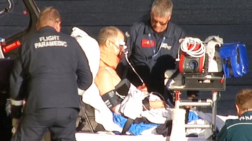 Paramedics with an injured man on a gurney