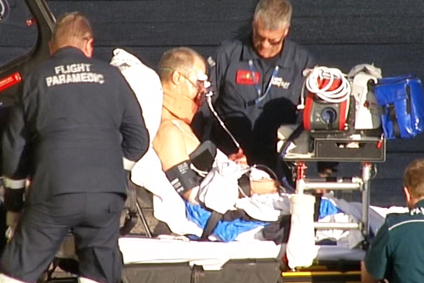 Paramedics with an injured man on a gurney