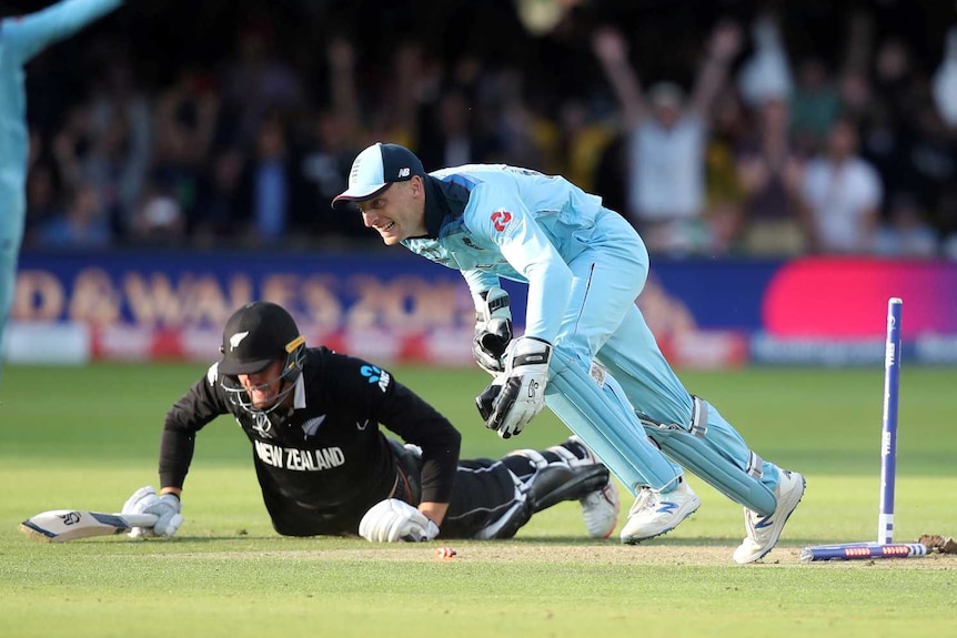England's Jos Buttler runs out New Zealand's Martin Guptill during the super over to win the World Cup