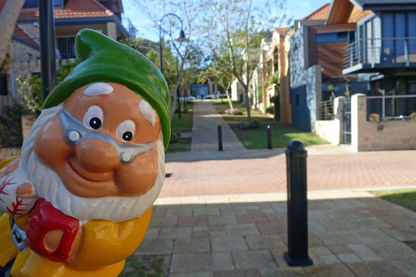 Gnome in street in East Perth with close up of figure in front of houses on hillside