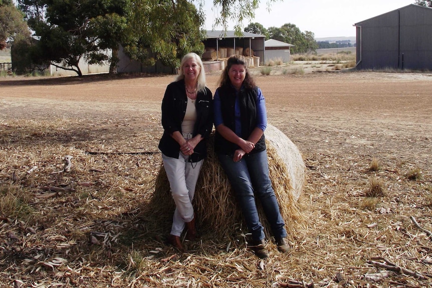 Leslee Holmes and Dahlia Richardson sitting on hay bale at the Badgingarra research station
