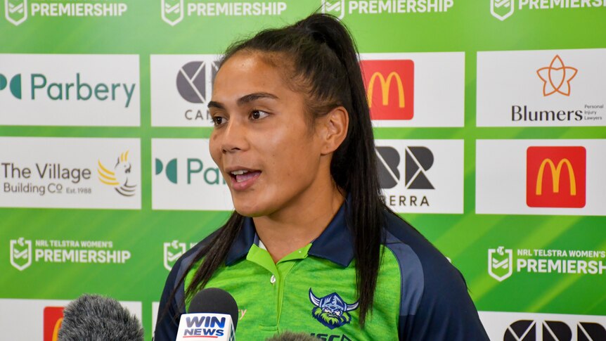 A woman being interviewed in uniform at a club Canberra Raiders press conference 