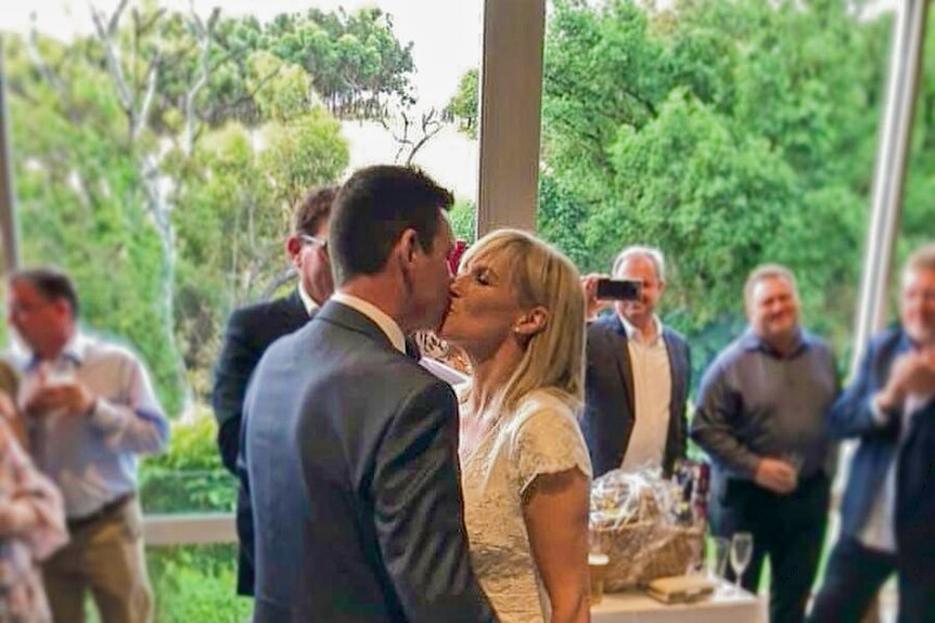 Christopher Grigg kisses his wife at their wedding