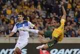 Tim Cahill has an aerial shot on goal against Kyrgyzstan