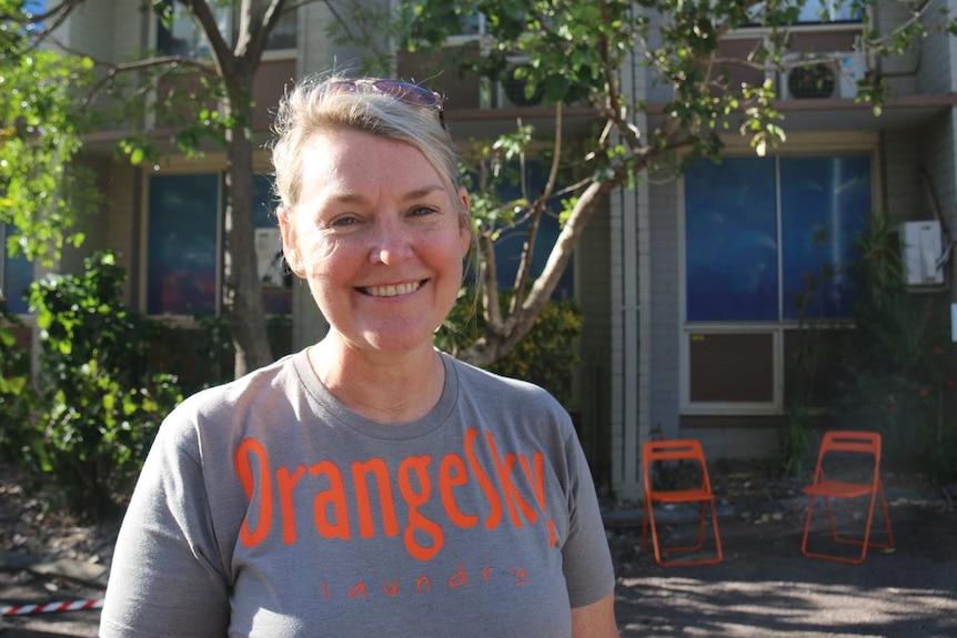 Lisa Sprlyan smiles while standing outdoors.