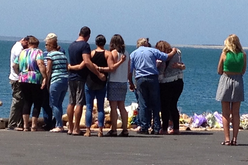 Family look at tribute for Little family at Port Lincoln