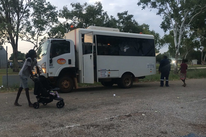 People waiting to get on a bus in Katherine.