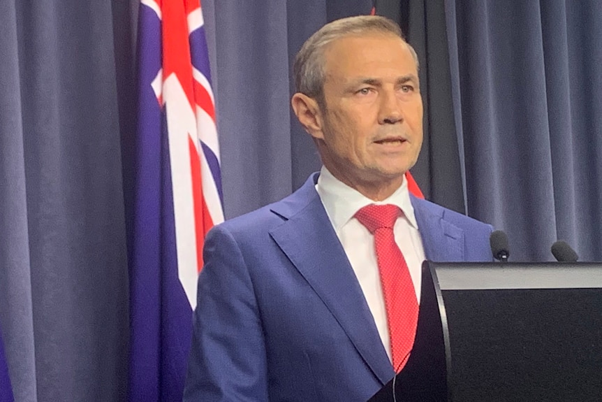 Headshot of a man at a lectern.