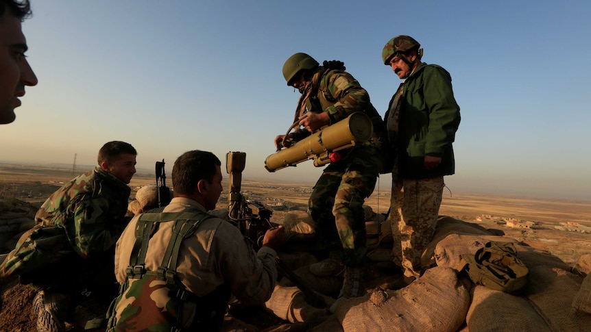 Peshmerga forces prepare their anti-tank guided missiles in front of Islamic State militants' positions.