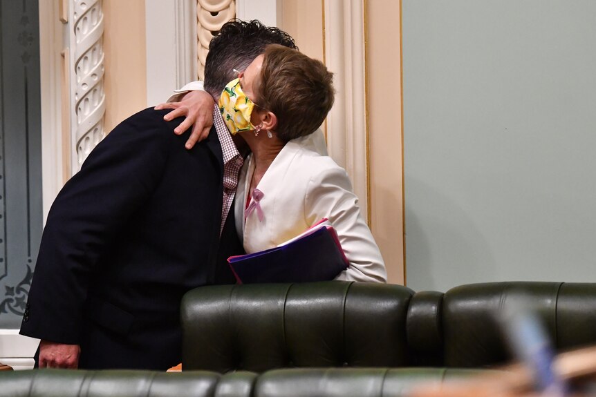 Member for Thuringowa Aaron Harper and Di Farmer embrace after voluntary assisted dying debate
