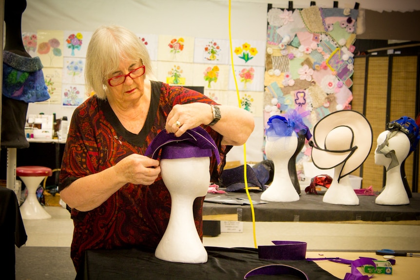 Lorraine Marter assembles a hat using pieces cut from a top hat.