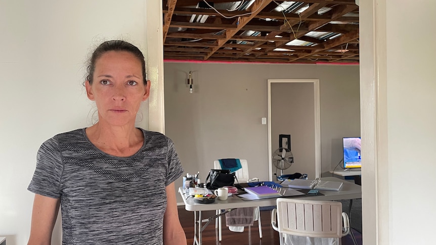 a woman in a room with an exposed roof.