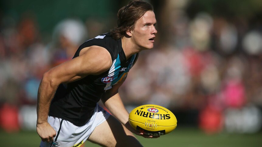 Port Adelaide's Jared Polec handballs in a preseason game against the Crows.