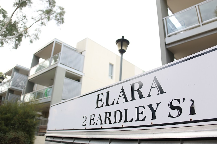 Letterboxes and signage outside the complex.