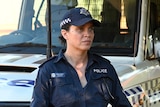 Jada Alberts as a police officer in the TV show Mystery Road, she leans against a police car