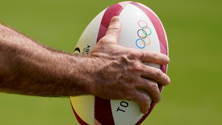 A member of Australia's men's rugby sevens team holds a ball during a practice at the Tokyo 2020 Olympics