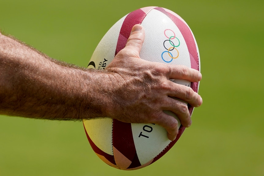A member of Australia's men's rugby sevens team holds a ball during a practice at the Tokyo 2020 Olympics