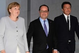 Angela Merkel, Francois Hollande and Matteo Renzi walking side-by-side.