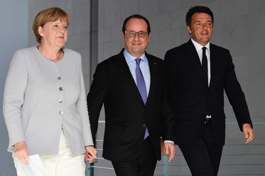 Angela Merkel, Francois Hollande and Matteo Renzi walking side-by-side.
