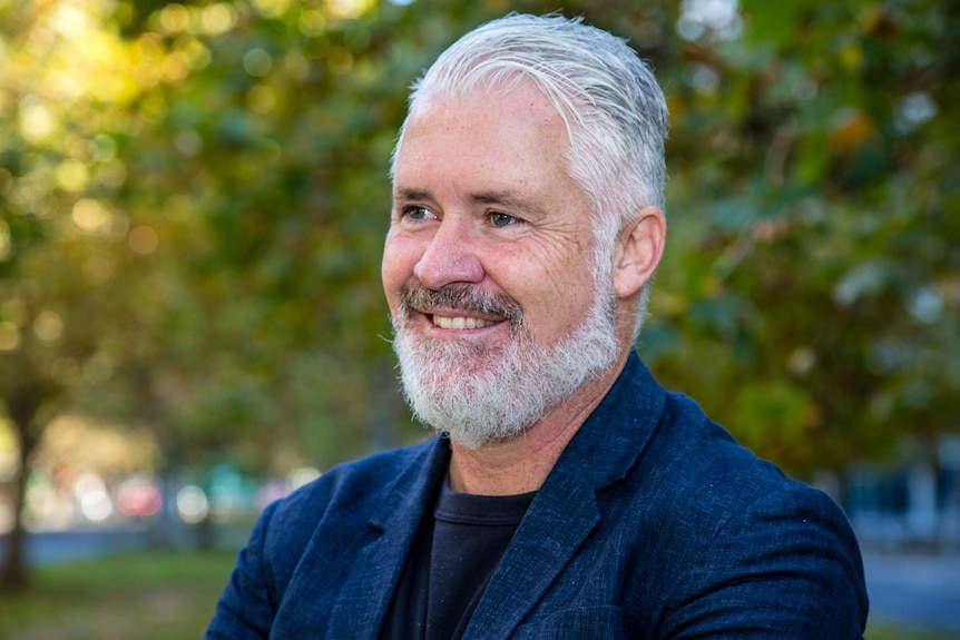 Rob Anderson smiling outdoors.