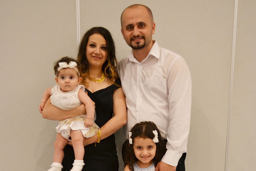 Anas Barbaree stands with his wife Maryam Meskonee and their two daughters Maram and Maya.