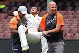 India's Prithvi Shaw (C) is carried off after rolling his ankle at the SCG on November 30, 2018.