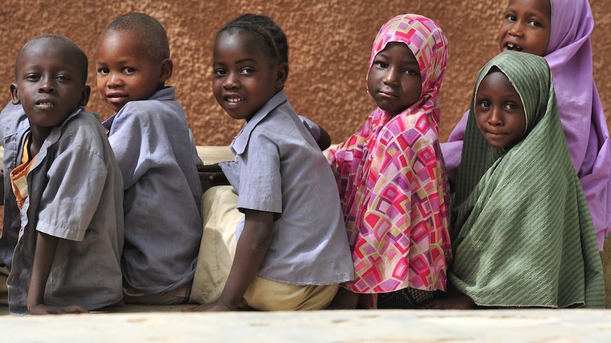 Children wait in line for a meal in Niger