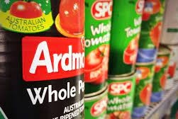 Cans of SPC products on a supermarket shelf