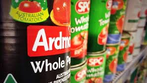 Cans of SPC products on a supermarket shelf