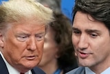 Donald Trump and Justin Trudeau lean in to converse.