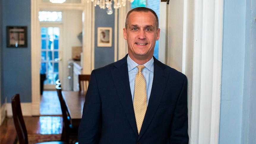 Mr Lewandowski leans on a doorframe as he smiles for the camera.