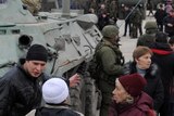 Locals speak near armoured personnel carrier in Crimea
